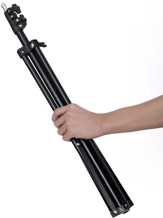 Black tripod held by a hand on a white background