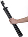 Black tripod held by a hand on a white background
